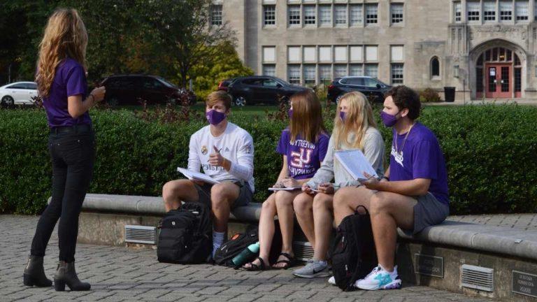 Students in front oval with masks